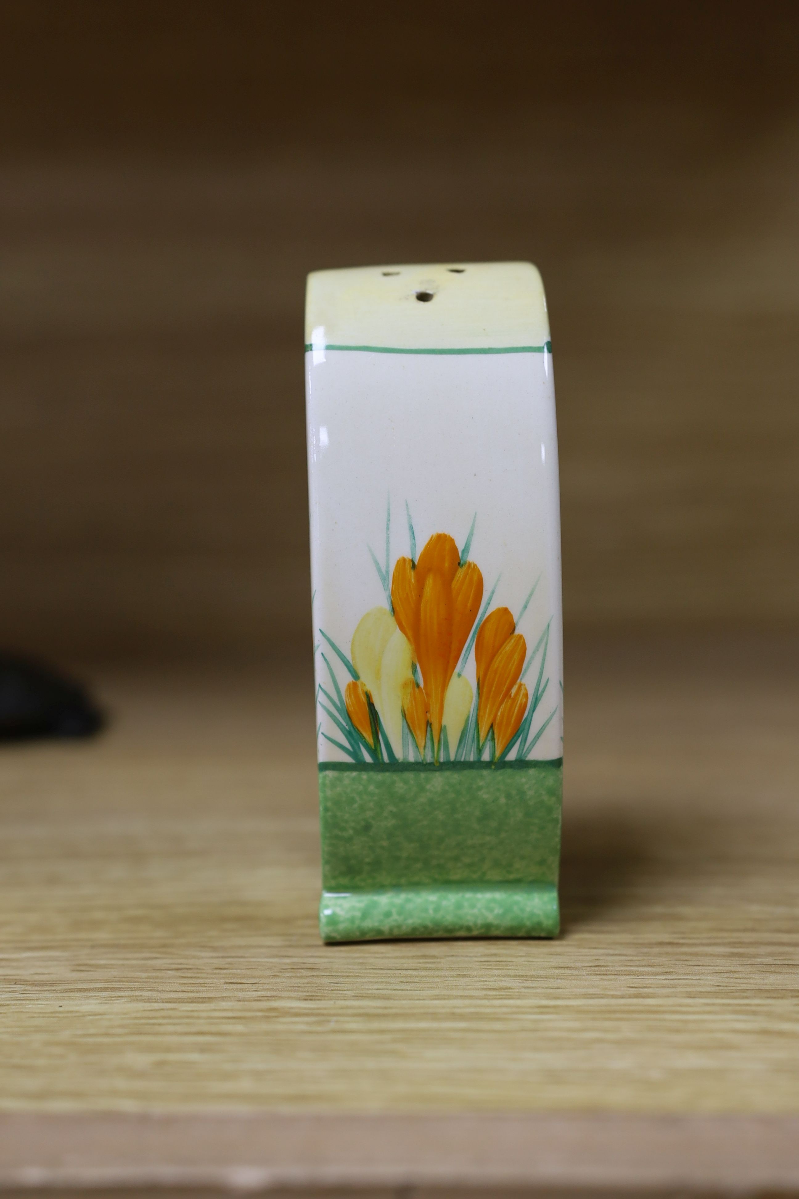 A Clarice Cliff sungleam crocus jam pot and cover, a sugar shaker and a Dutch clog ornament (3), jam pot and cover 10 cms high